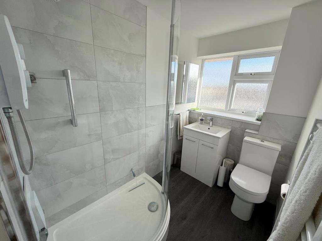 Lot: 1 - TWO-BEDROOM TOP FLOOR APARTMENT IN COASTAL LOCATION - Bathroom with electric shower wc, basin and heated towel rail